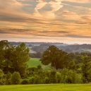 The last sunrays over the park and the mist starts to cover the western hills