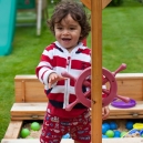 Eric at the wheel of the play boat in our garden