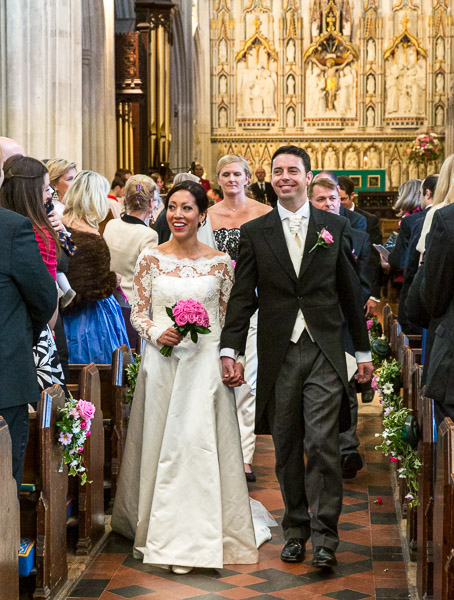 The bride and groom walking out as  husband and wife