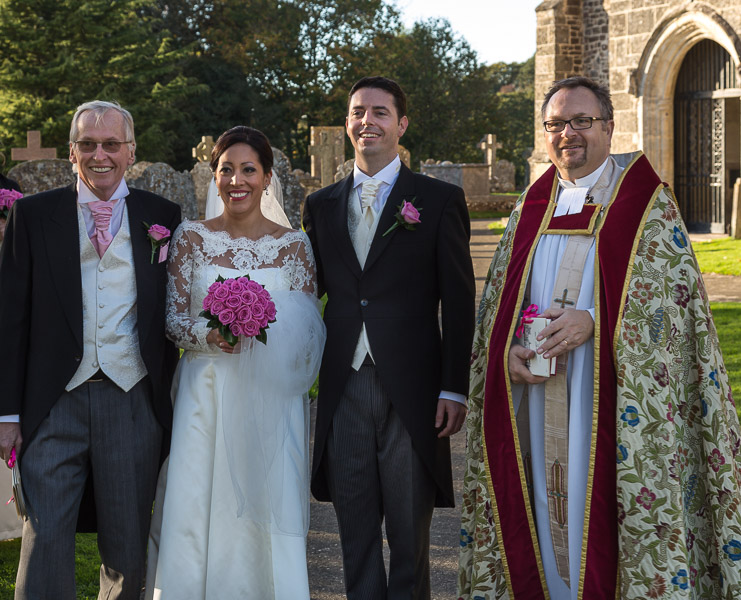 Michael and I surround the bridal couple