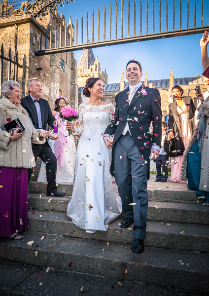 Confetti being trown at the couple on the church steps