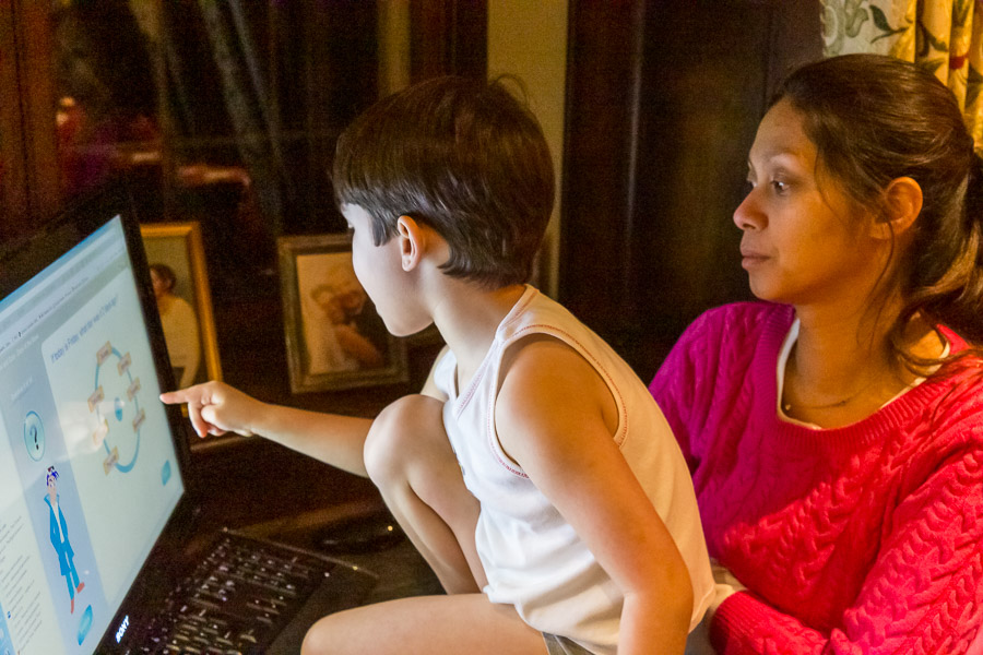 Eric studying using our Library touchscreen under the supervision of Mama