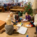 …while Eric is playing with the other children in front of the pews