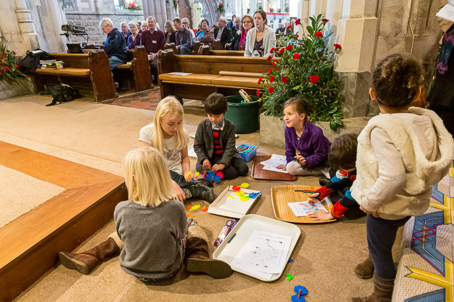 …while Eric is playing with the other children in front of the pews