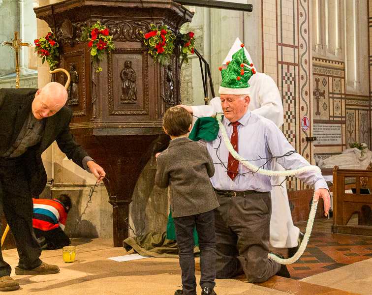 Dressing a living Christmas tree at the Church at Christmas